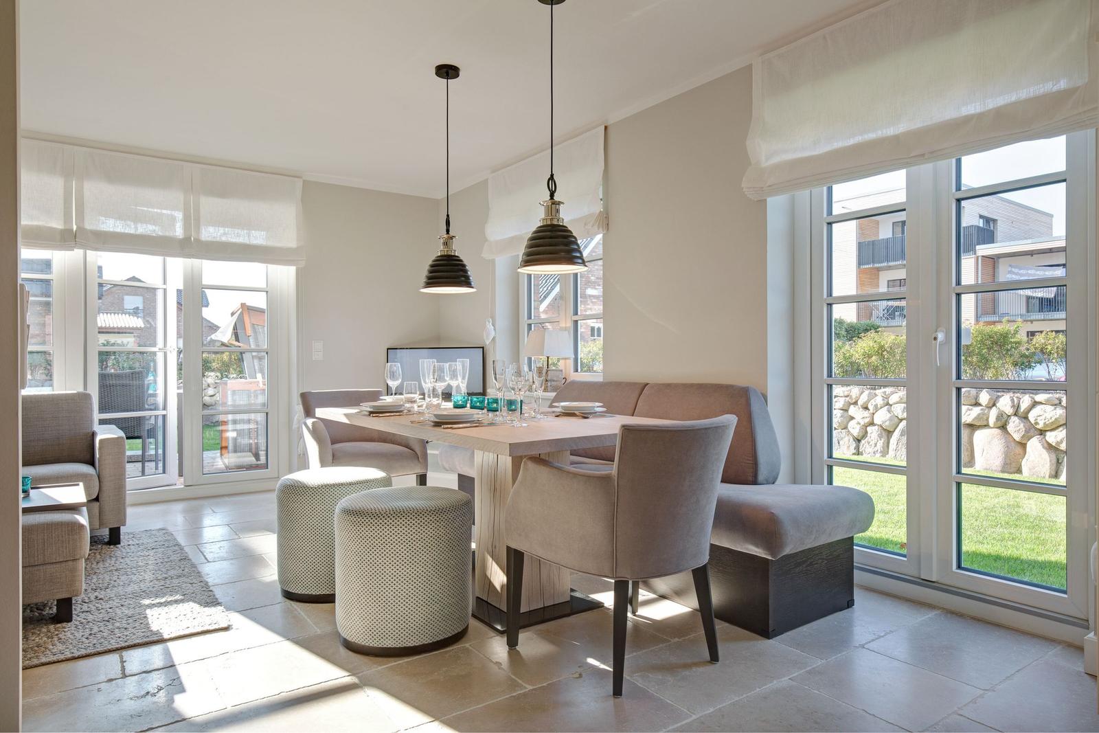 Dining area with table, chairs, and windows to the outside.