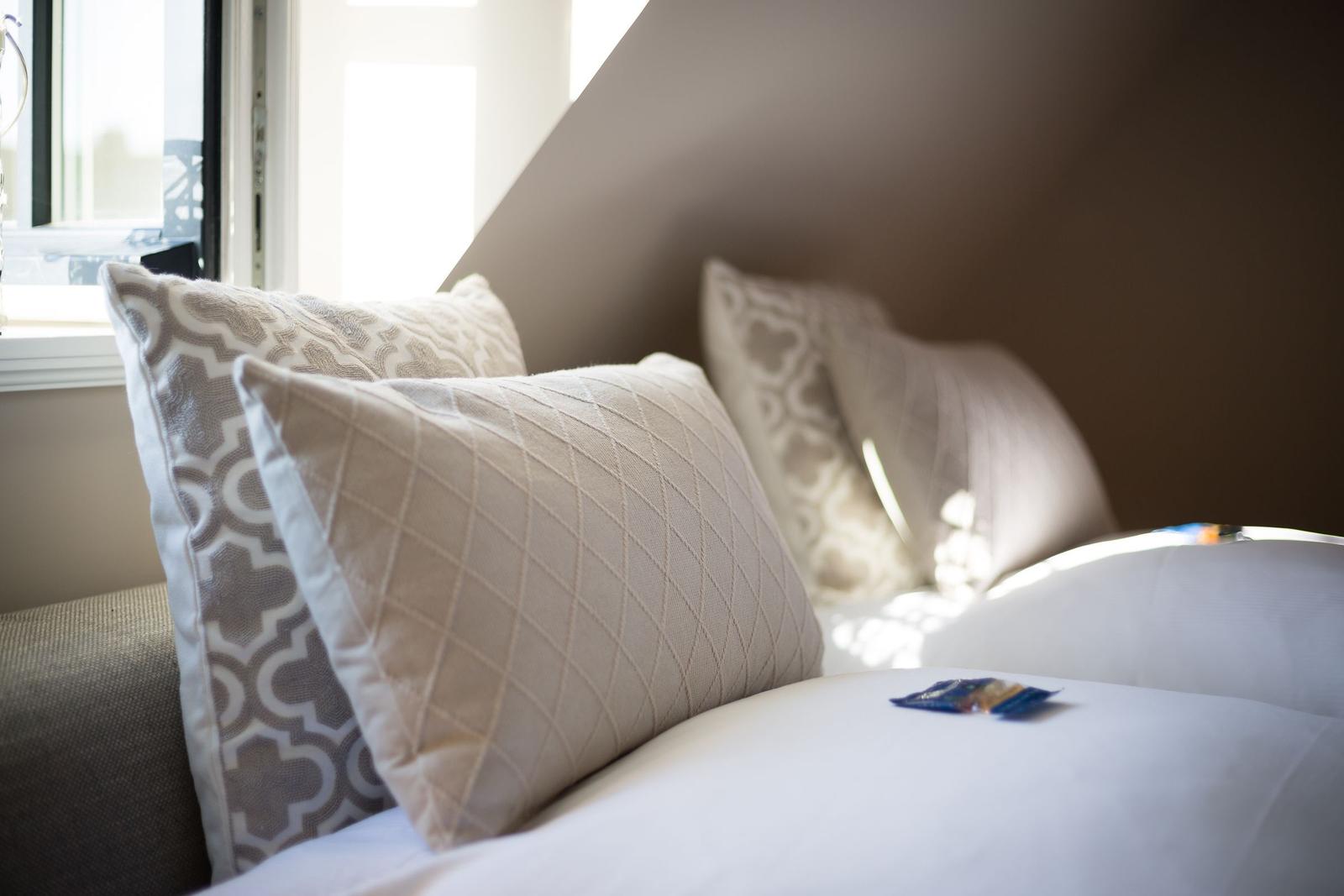 Bed head with pillows and window in background