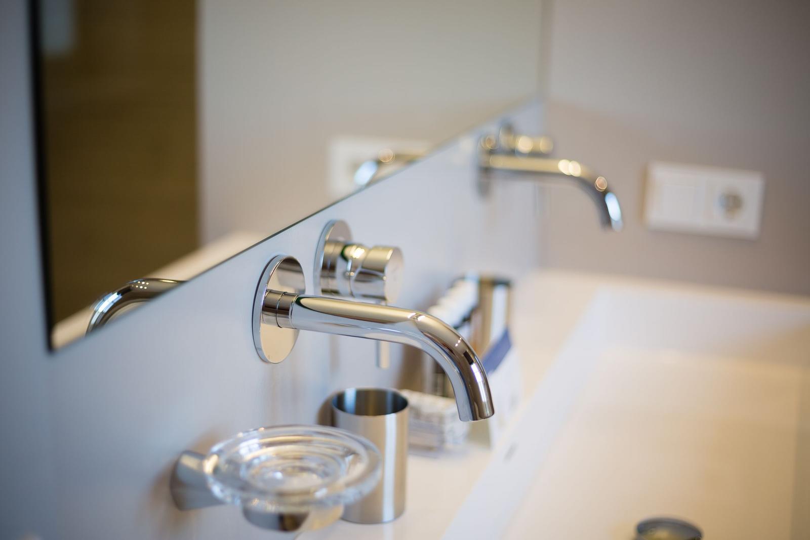Bathroom with modern faucet and mirror cabinet
