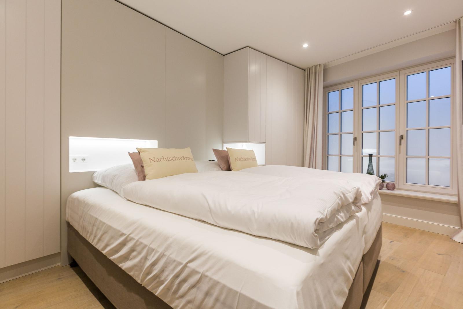 Bedroom with double bed, built-in closet, and window with view.