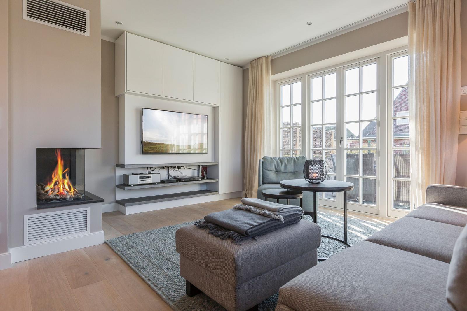 Living room with fireplace, TV, and large window