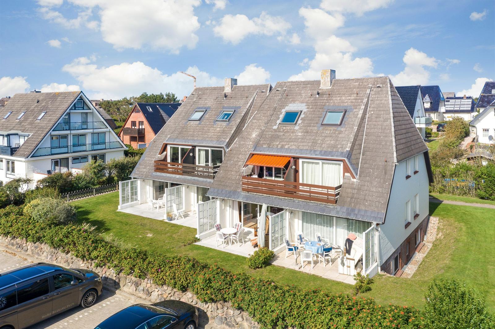 House with balcony, terrace, and garden. Multiple windows and skylights visible.