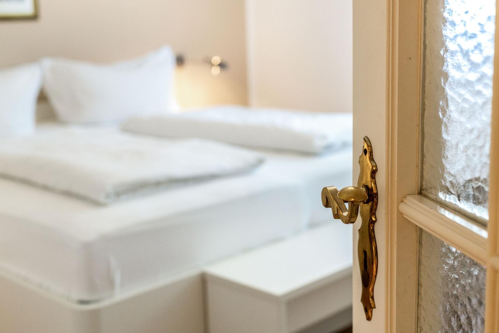 Bedroom with bed and golden door handle