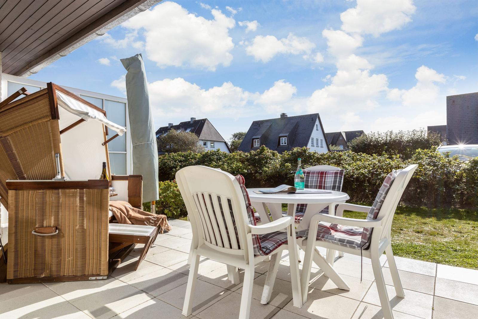 Terrace with table, chairs, and view of houses