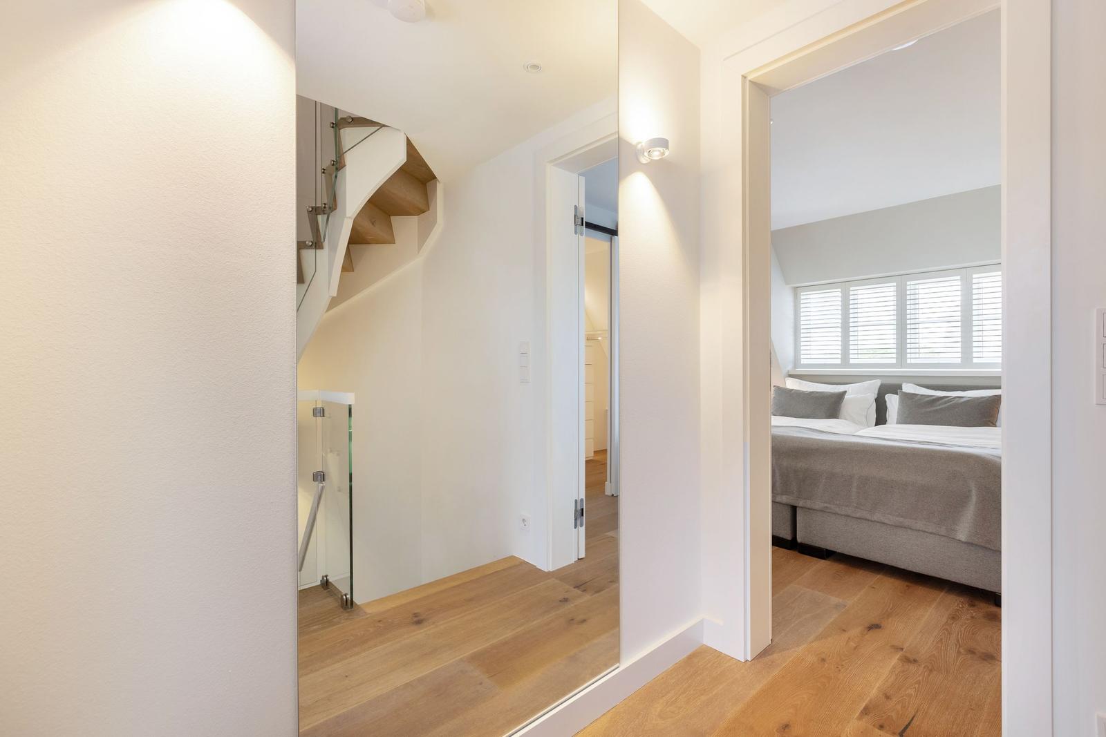 Höhlenartige Eingangshalle mit Blick auf Schlafzimmer und Treppe.