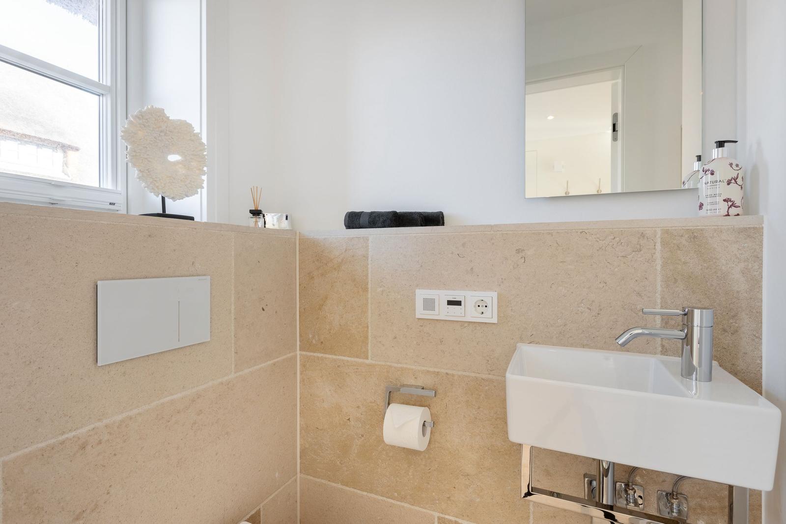 Bathroom with sink, mirror and window