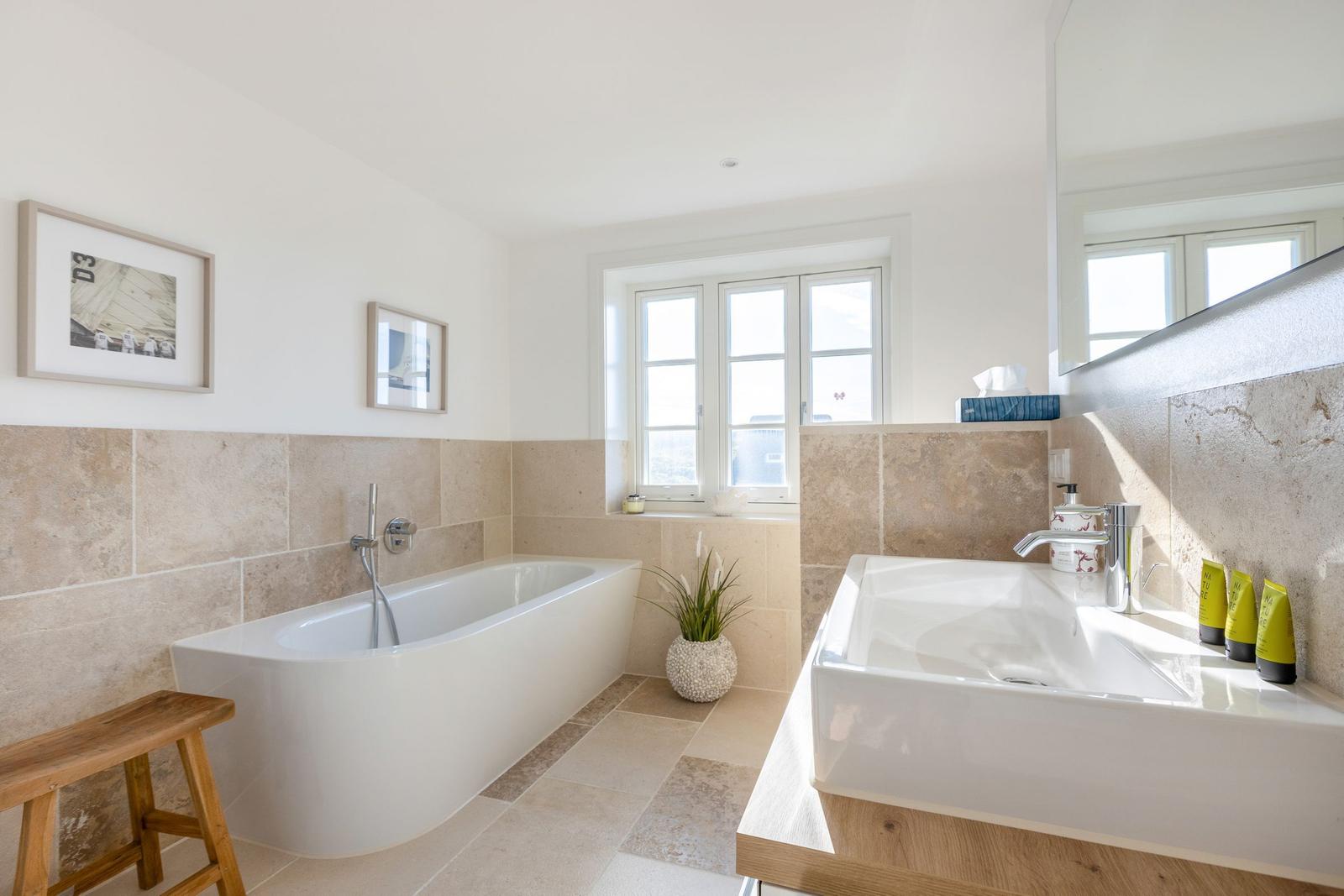 Bathroom with freestanding bathtub and sink with mirror