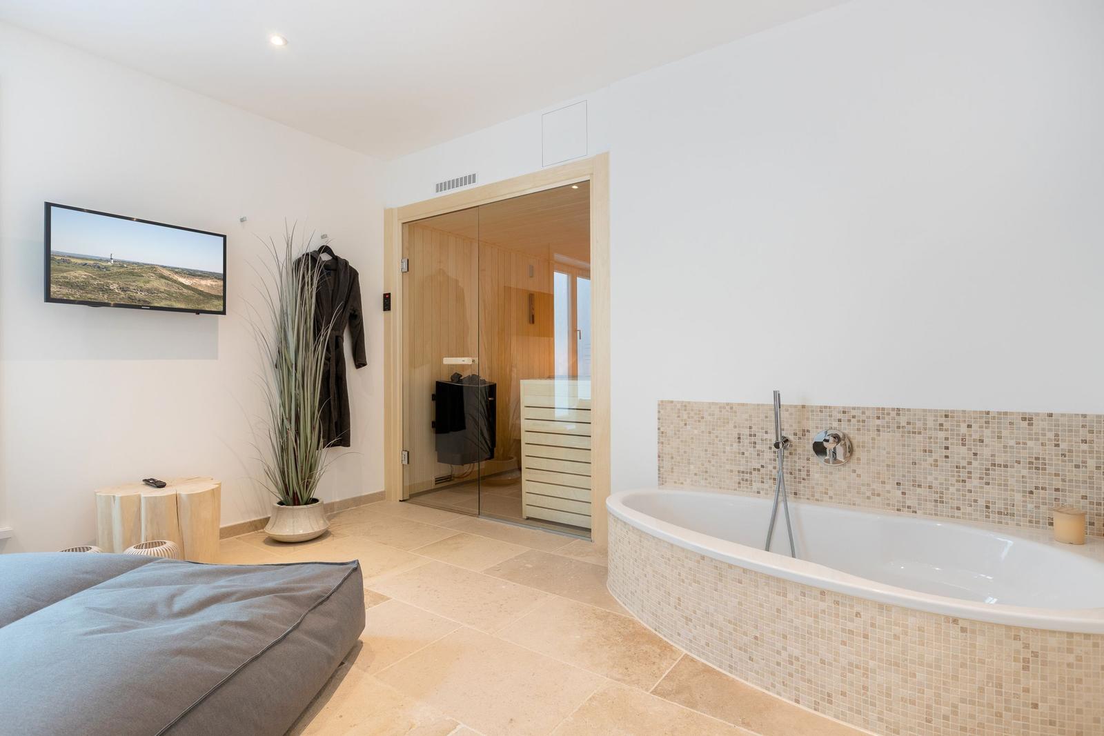 Bath with whirlpool, sauna, and TV