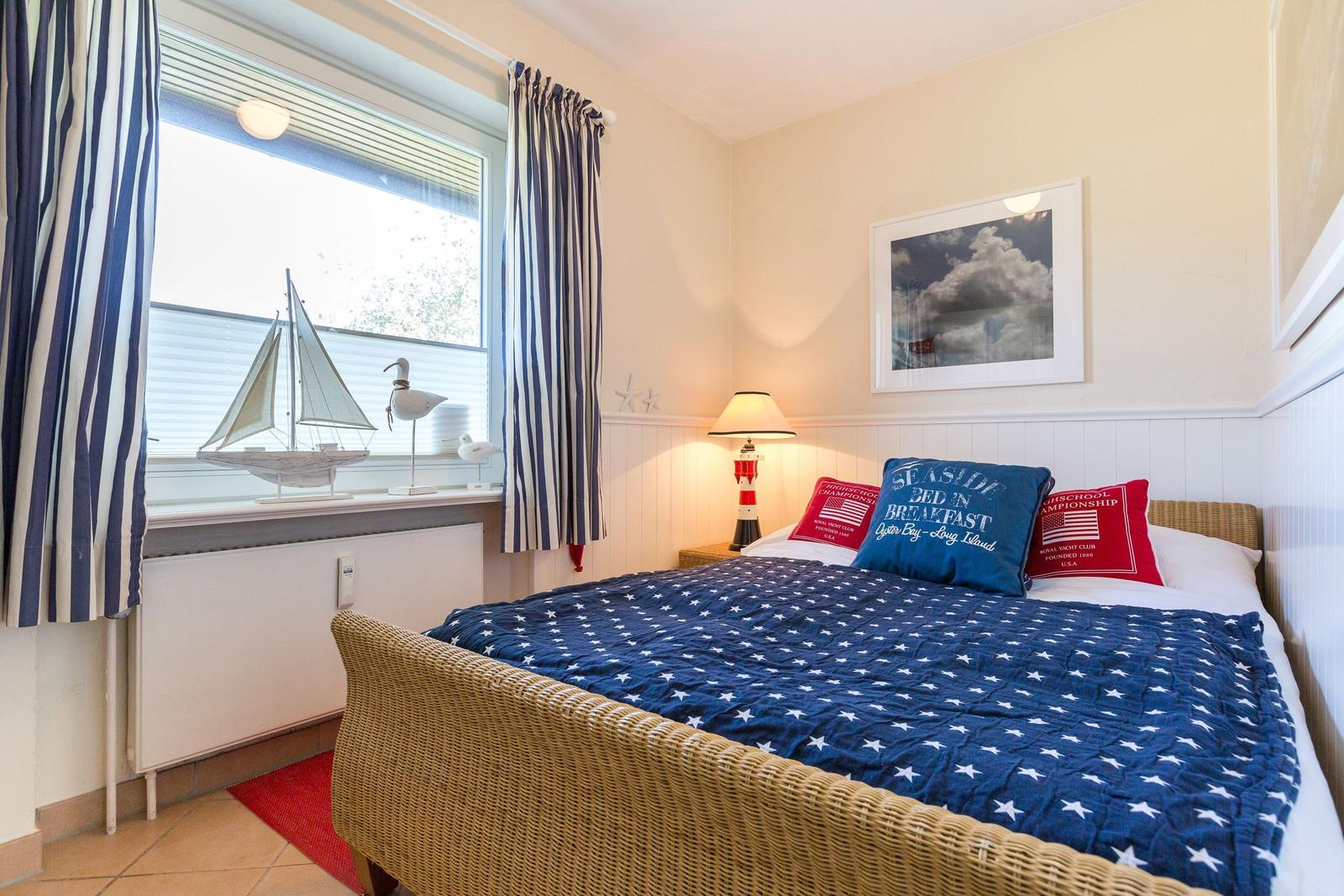Bedroom with bed, window, and decor.