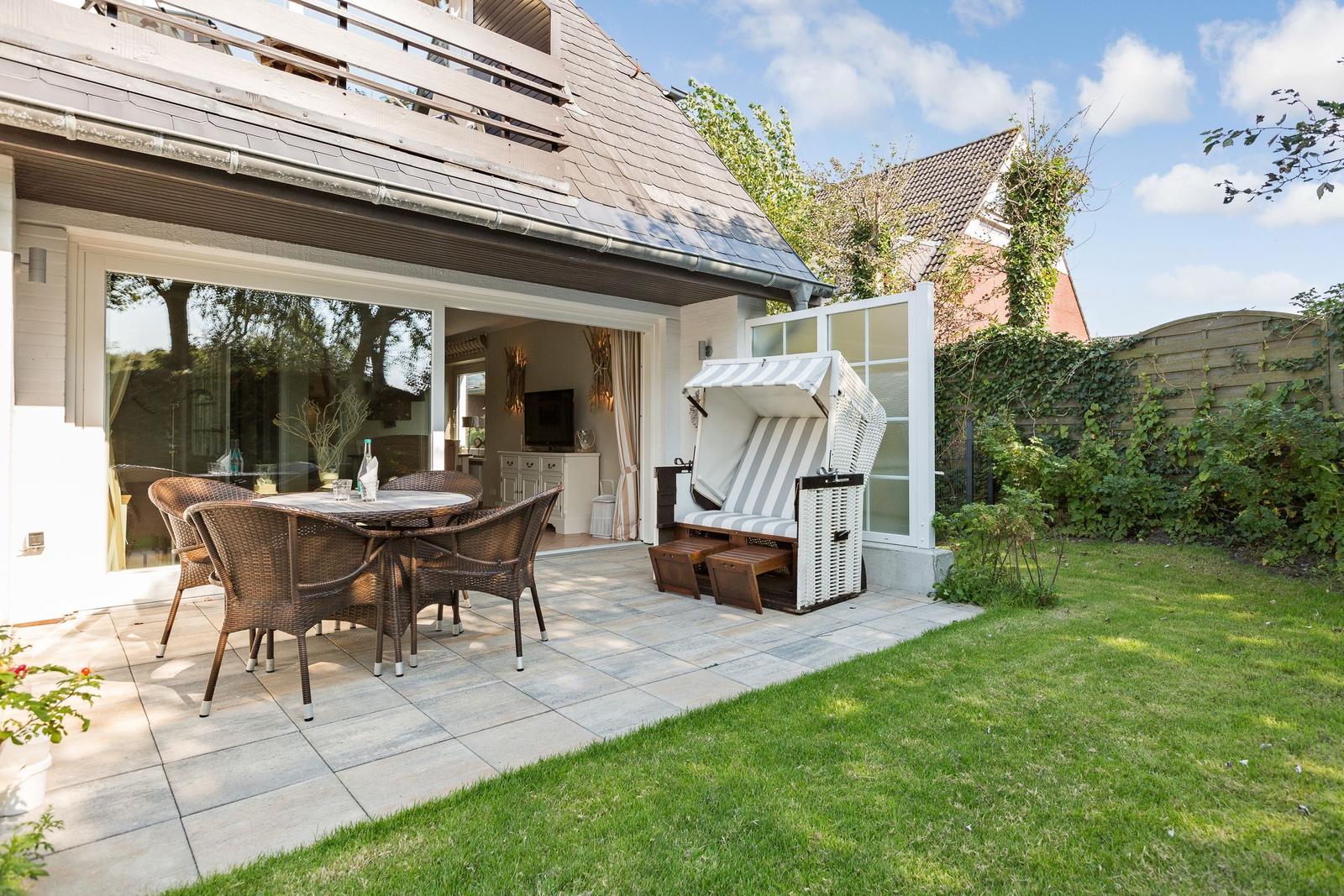 Terrace with dining table, lounge chair, and lawn