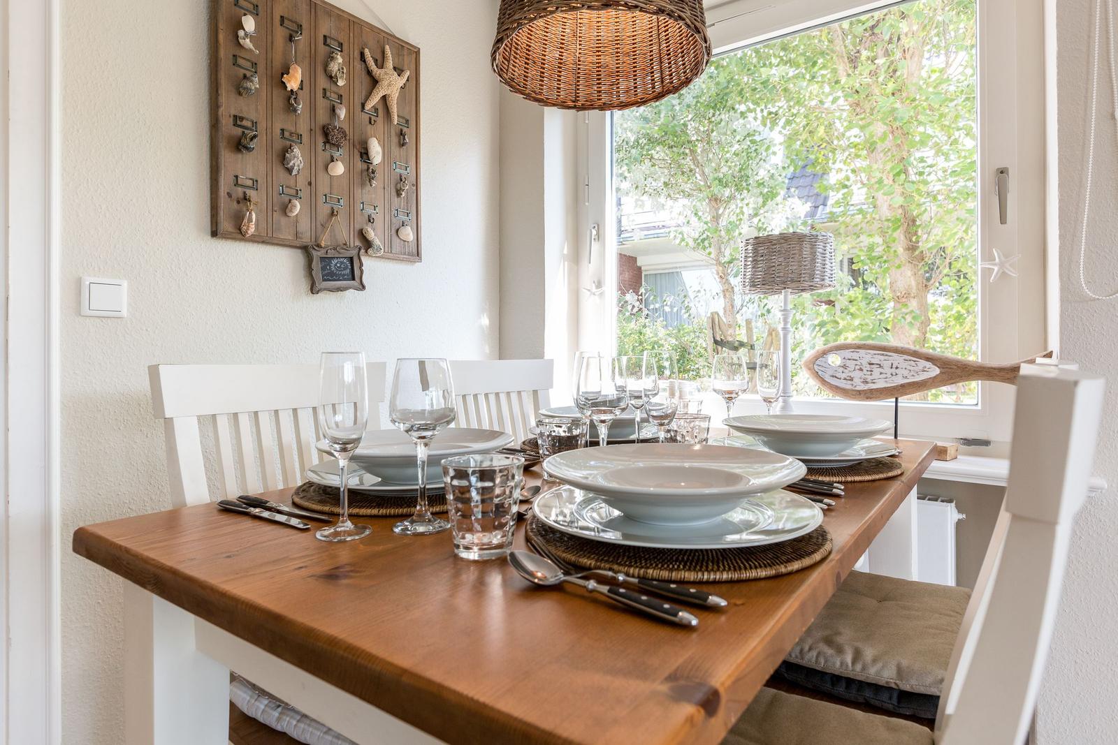 Dining table with chairs and garden view through window