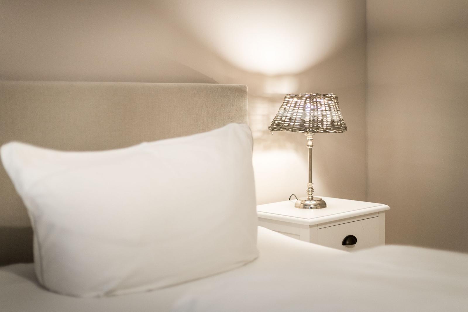 Bed head with pillow and nightstand with lamp