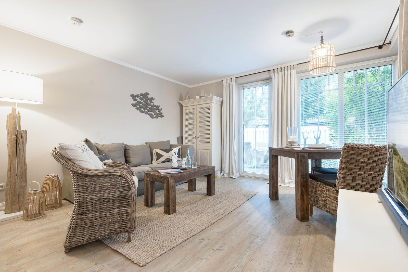 Living and dining area with sofa, dining table, and balcony view.