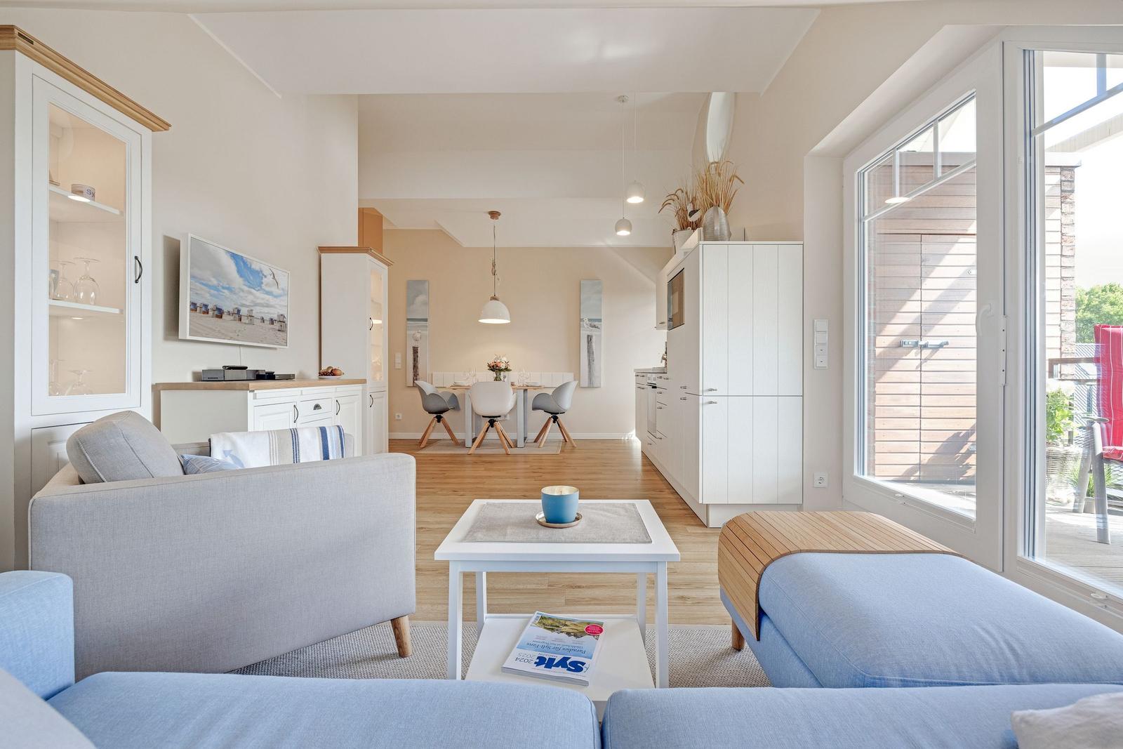 Living room with sofa, coffee table, and view of terrace