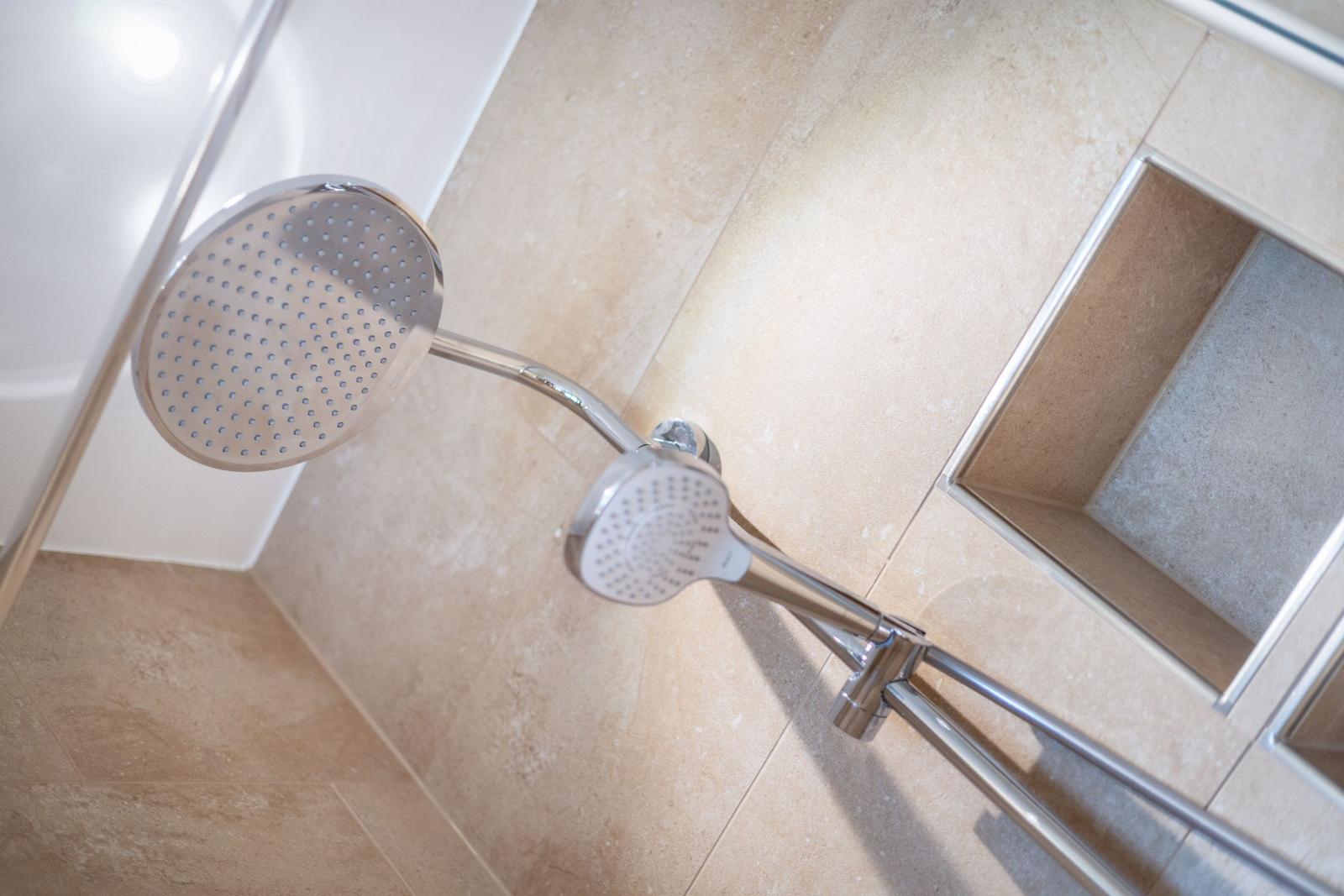Shower area with shower head and handheld shower