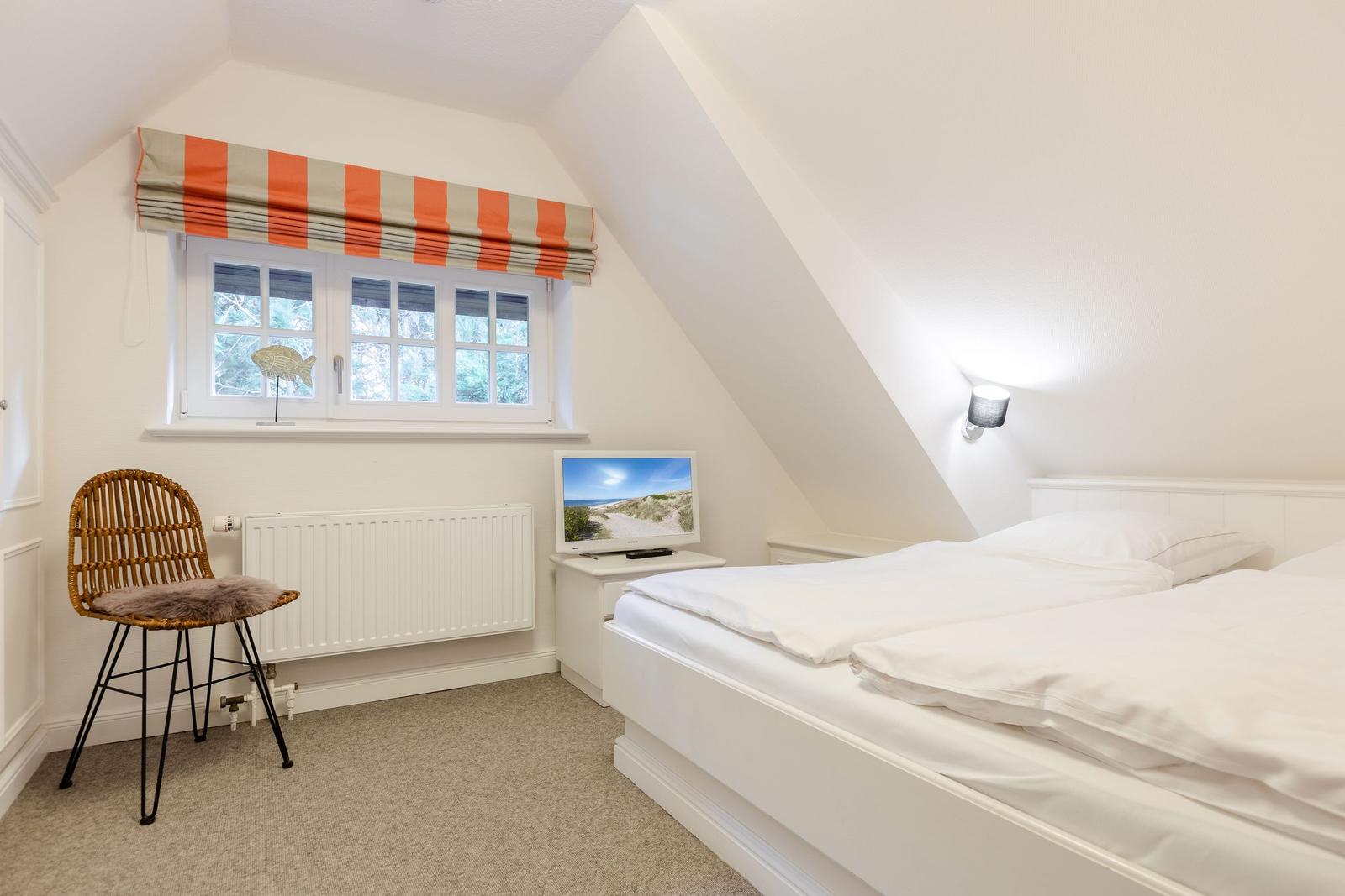 Bedroom with double bed, window and chair