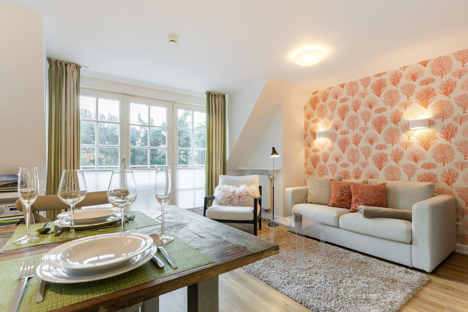 Living and dining area with sofa, table, and window.