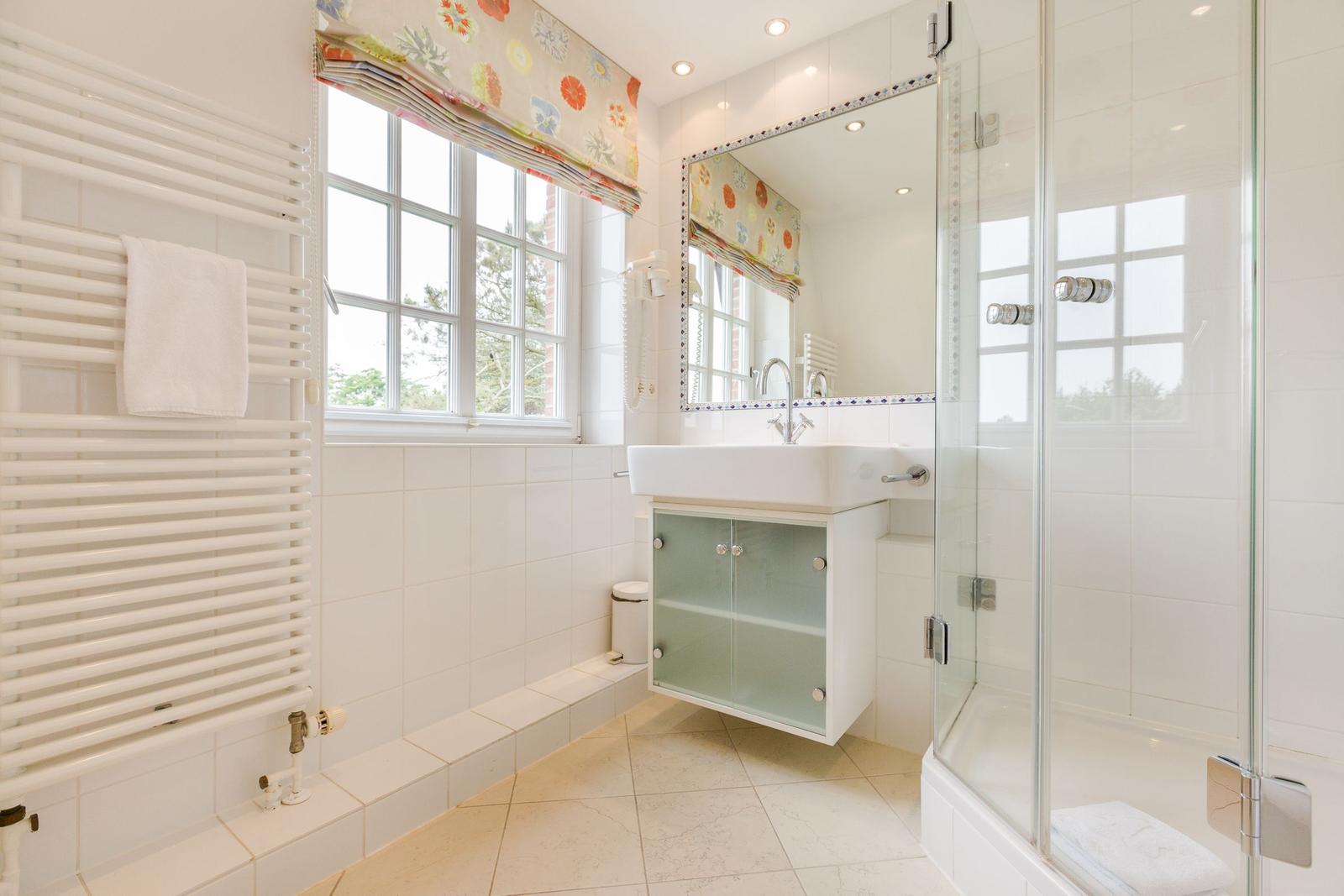 Bathroom with shower, sink and window