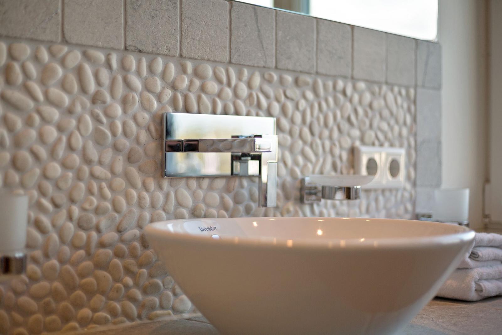 Sink with stone wall and chrome faucet