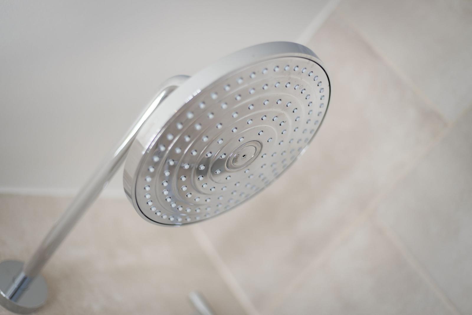Shower head with multiple nozzles in a bathroom