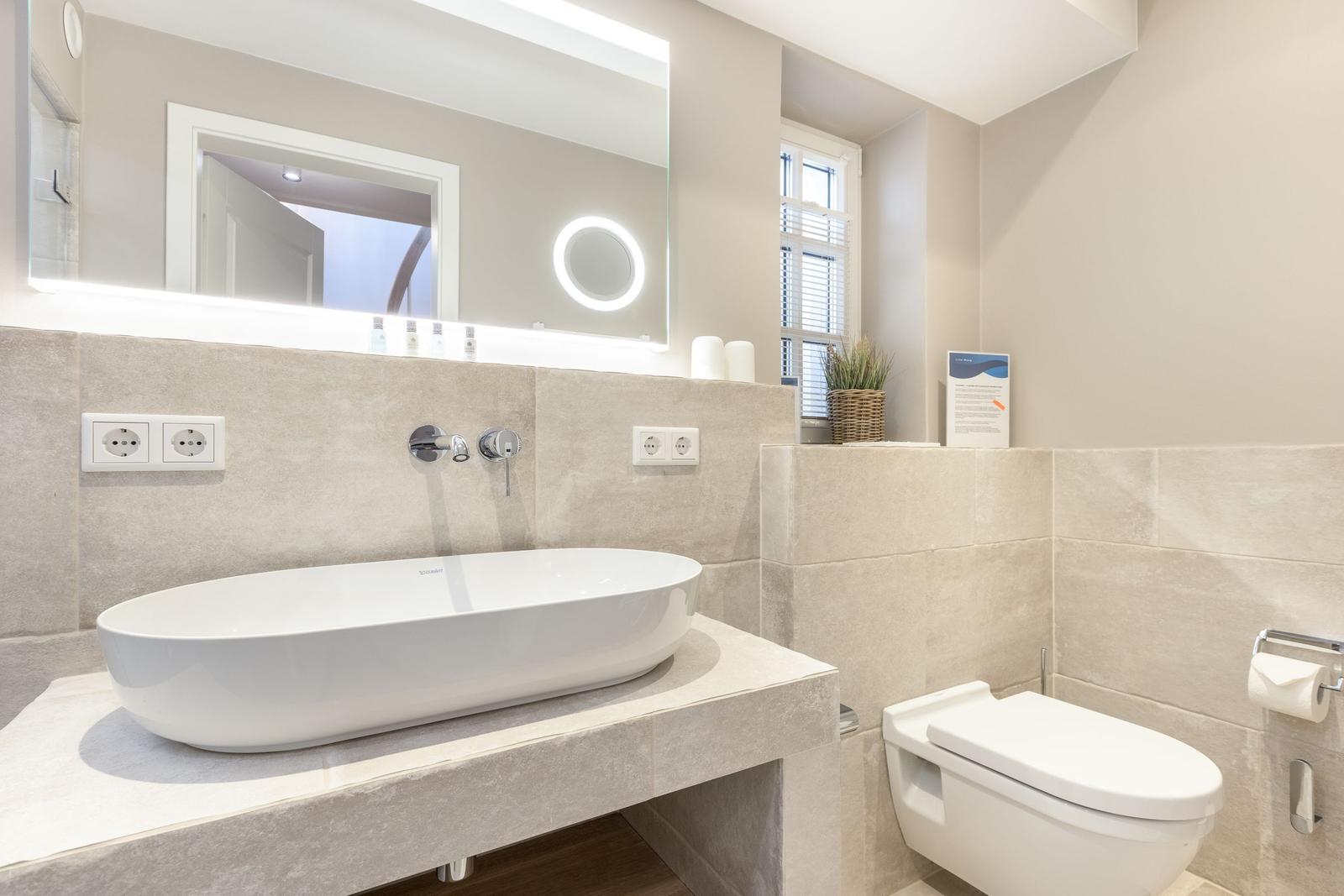 Bathroom with sink, mirror, and toilet