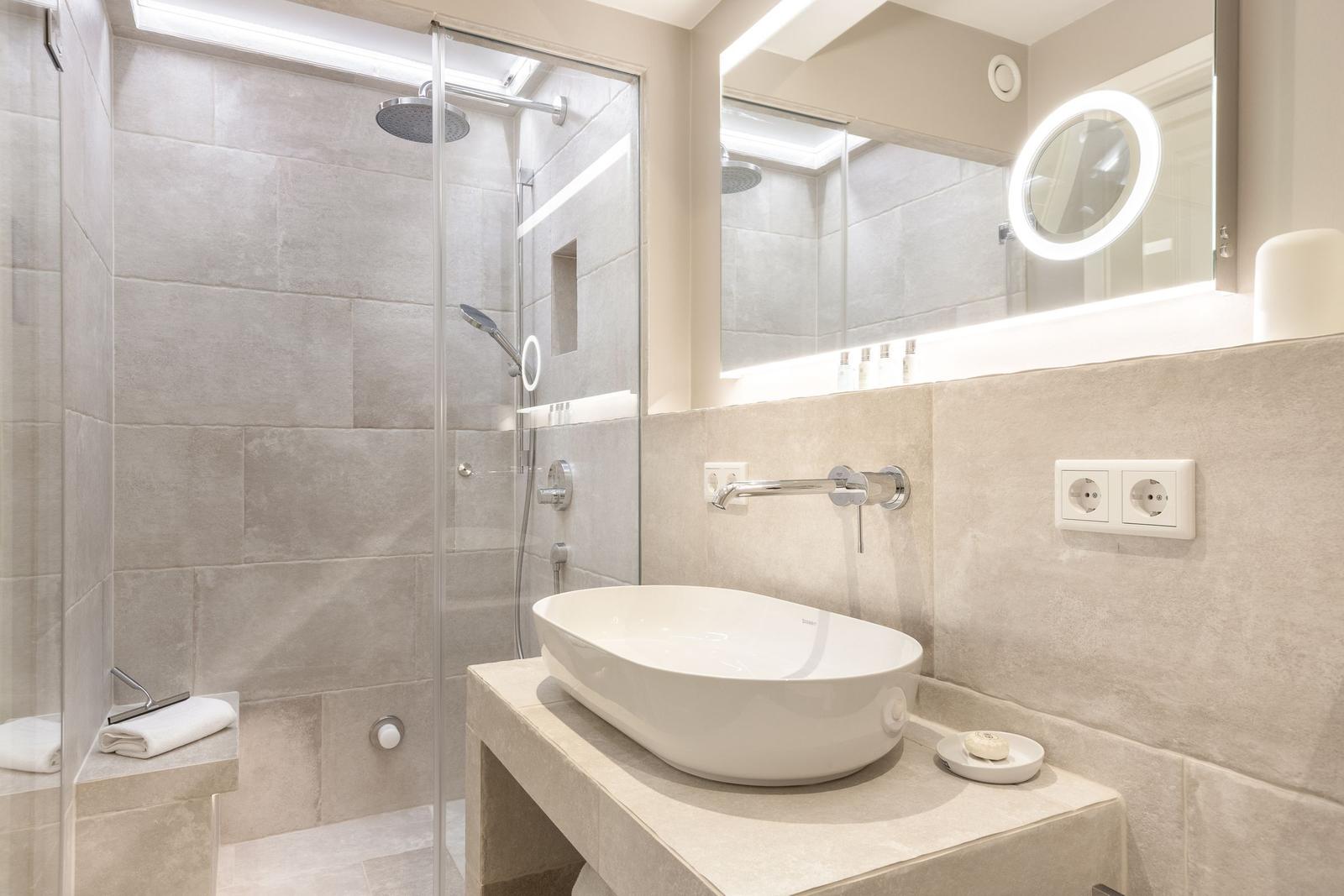 Bathroom with shower, sink, and mirror