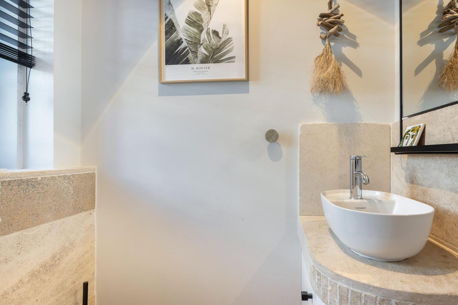 Sink with mirror and wall decoration