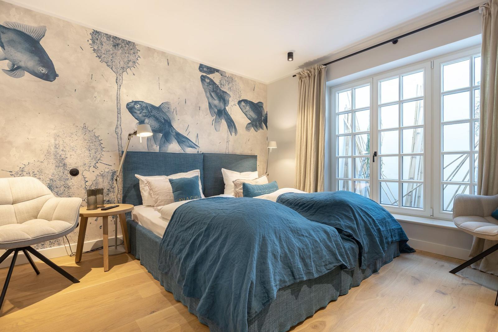 Bedroom with bed, fish wall and window