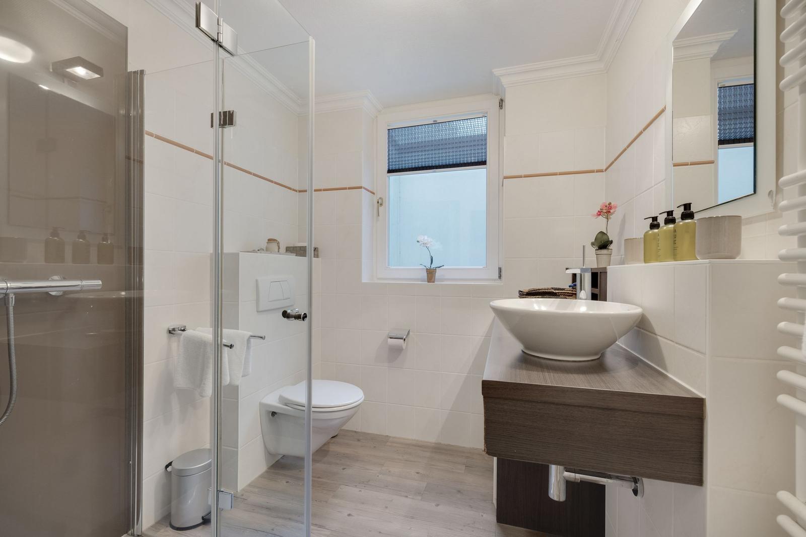 Bathroom with shower, toilet, and sink