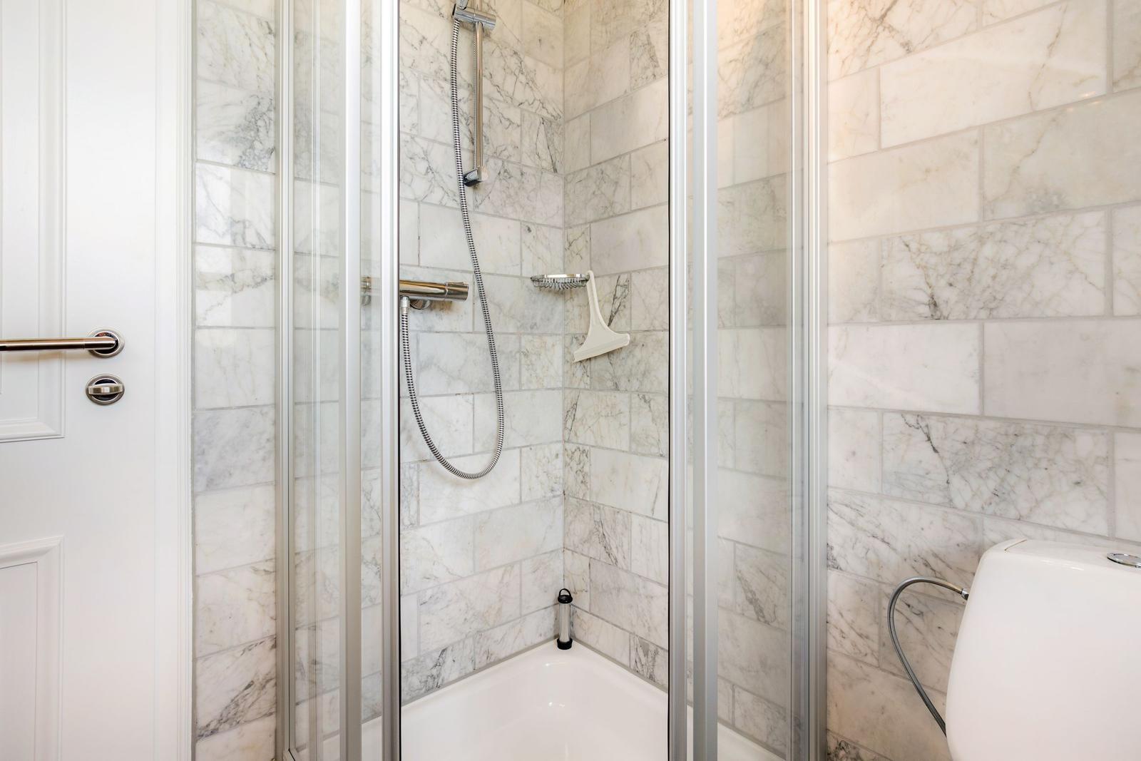 Shower with marble wall and showerhead