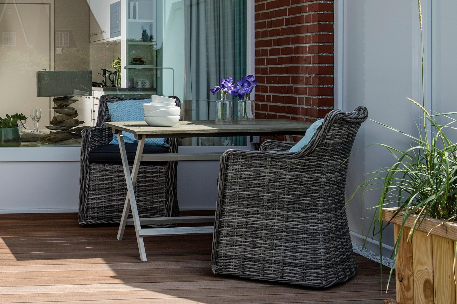 Terrace with table, two chairs, and flowers