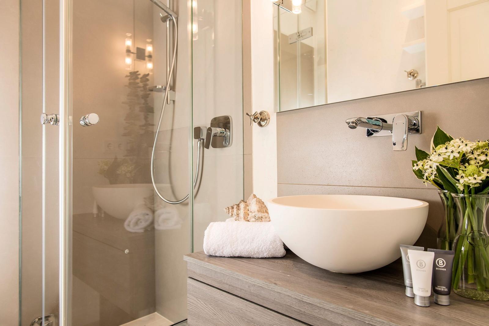 Bathroom with shower cabin, sink, and towel