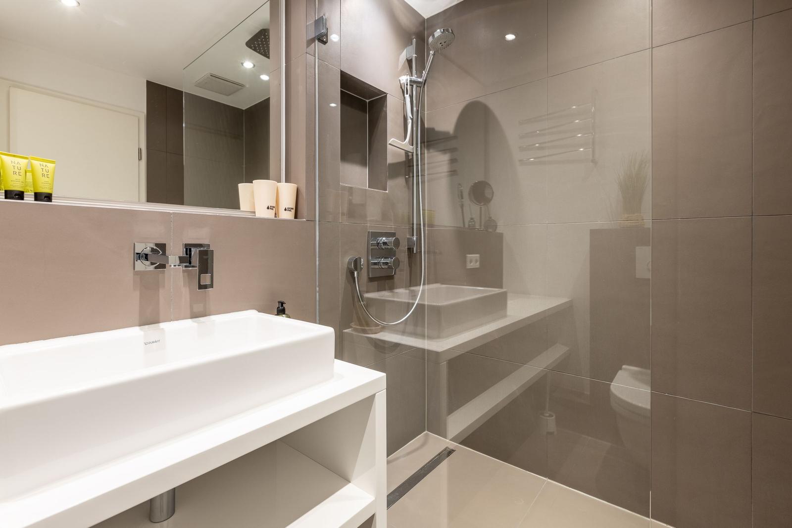 Modern shower with showerhead and sink in the bathroom
