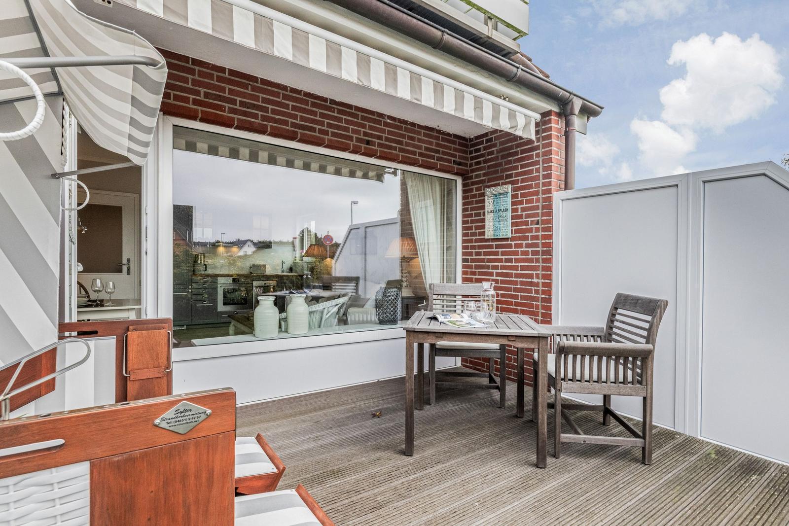 Terrace with table, chairs, and view into the house