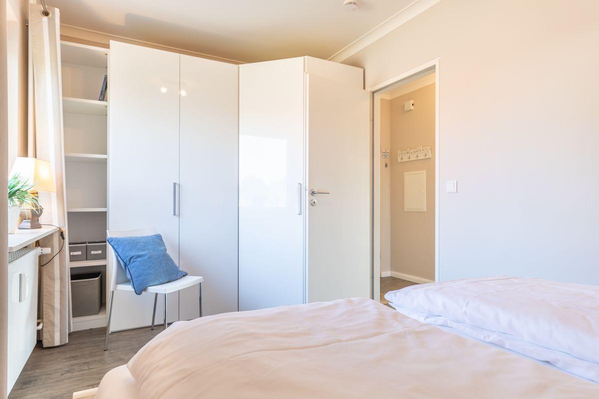 Bedroom with bed, wardrobe, and desk