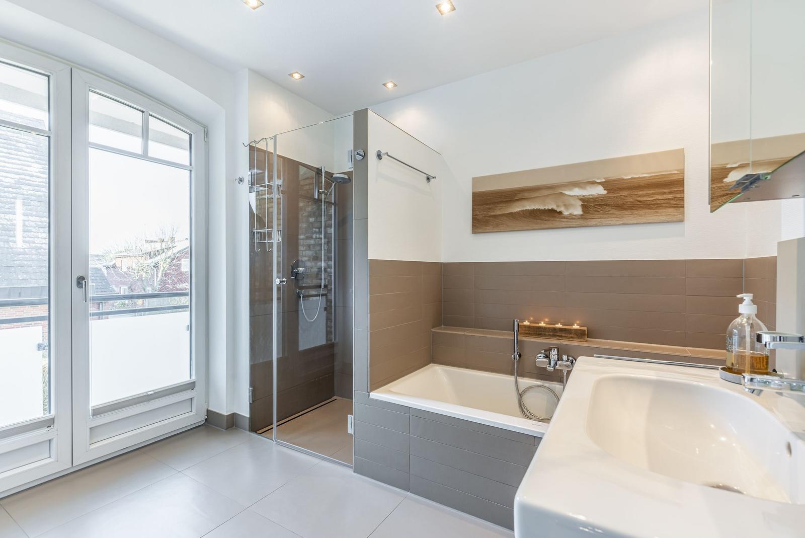 Bathroom with shower, bathtub, and window to terrace