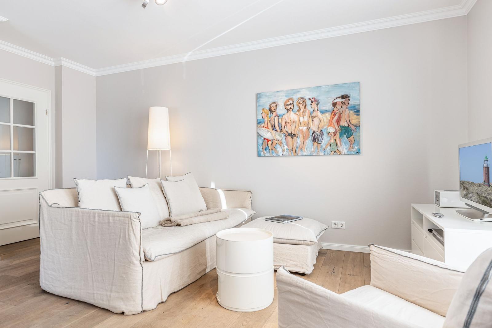 Living room with sofa, TV, and wall painting