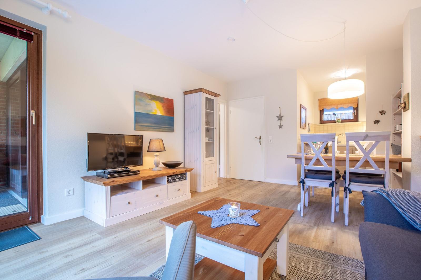 Living and dining area with wooden furniture and TV