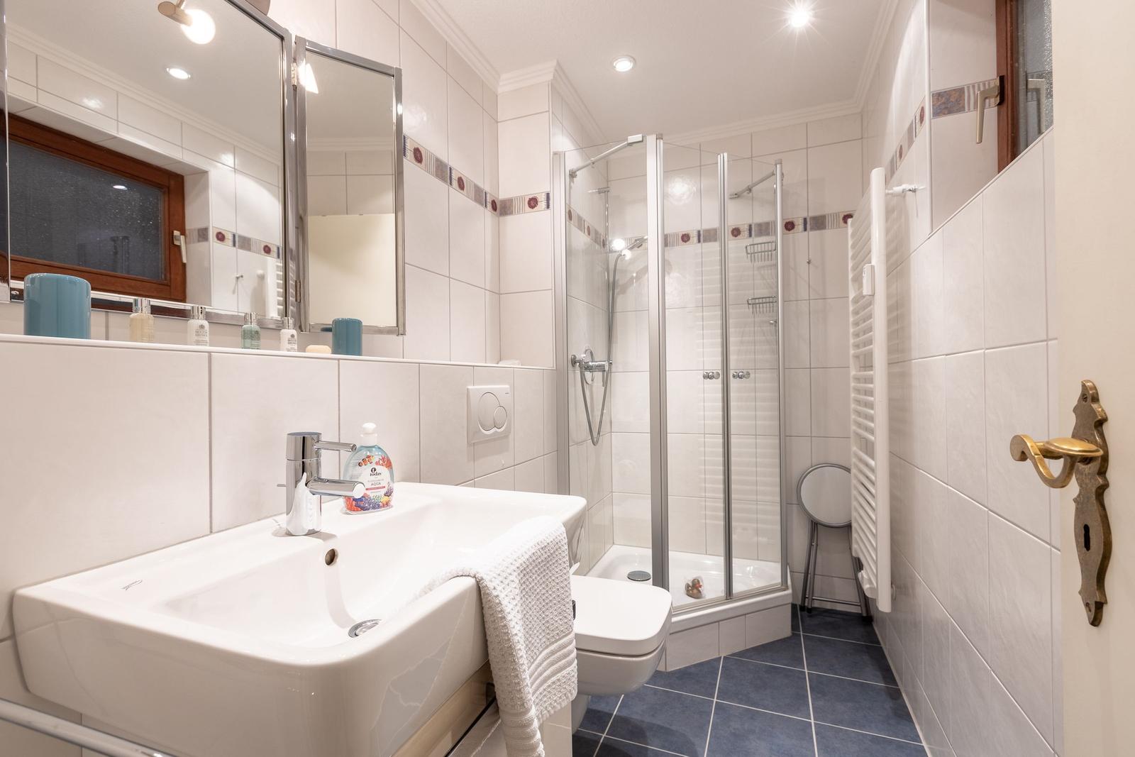 Bathroom with shower, sink, and toilet
