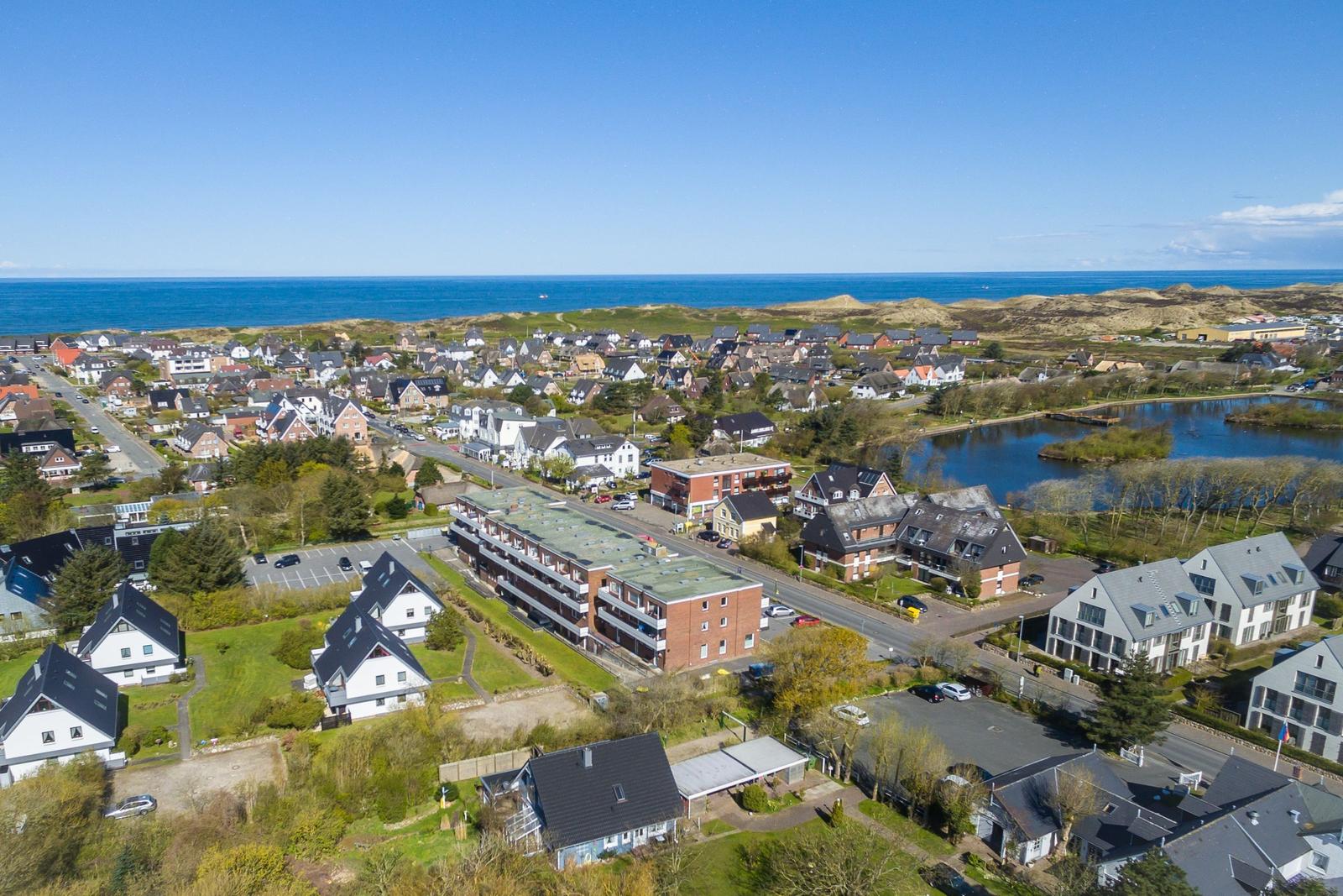 View of coastal town with houses and sea