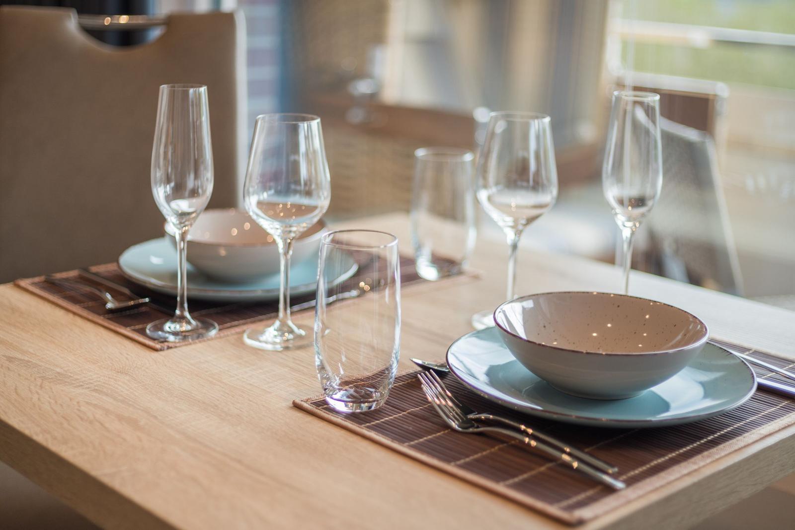 Table set with dishes and glasses for four people