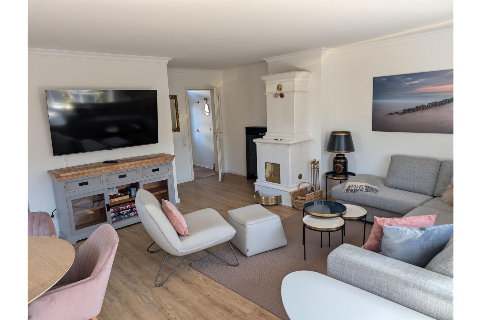 Living room with sofa, TV, and fireplace