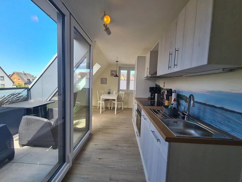 Kitchen with view of terrace and dining area