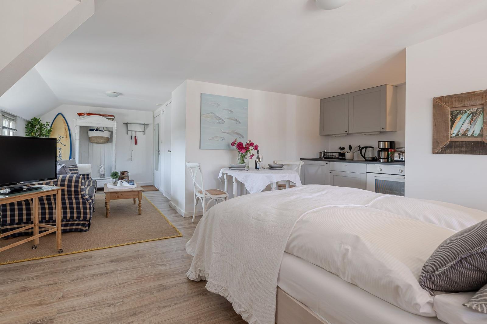 Bedroom with kitchen area and living space in a vacation home.