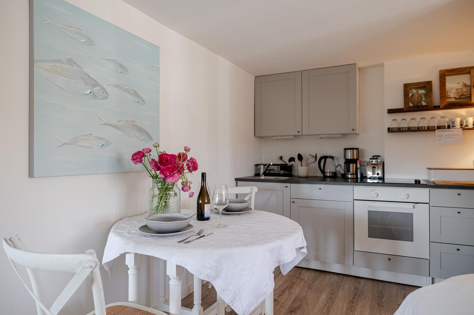 Kitchen with dining table, wall art, and kitchen appliances.
