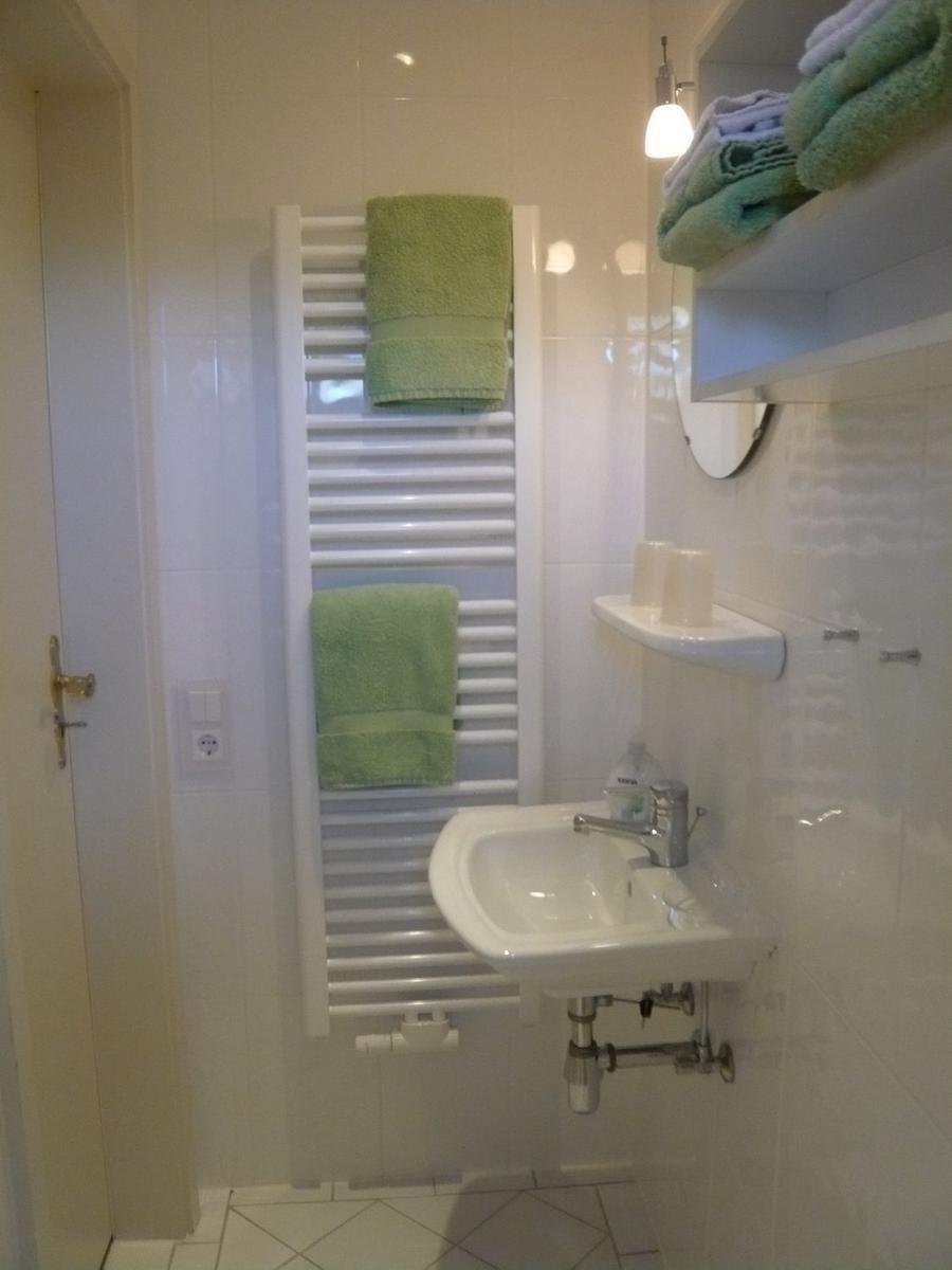 Bathroom with sink, towel rack, and towels.