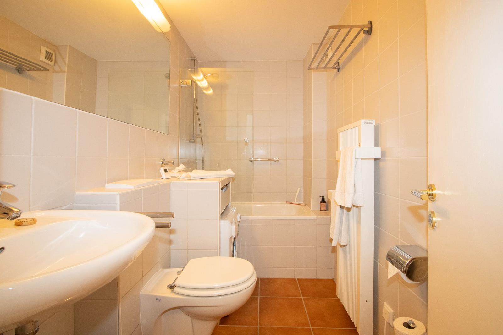 Bathroom with shower, sink, and toilet.
