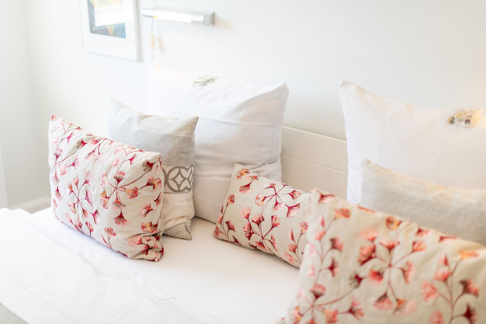 Bed headboard with pillows and wall lamp