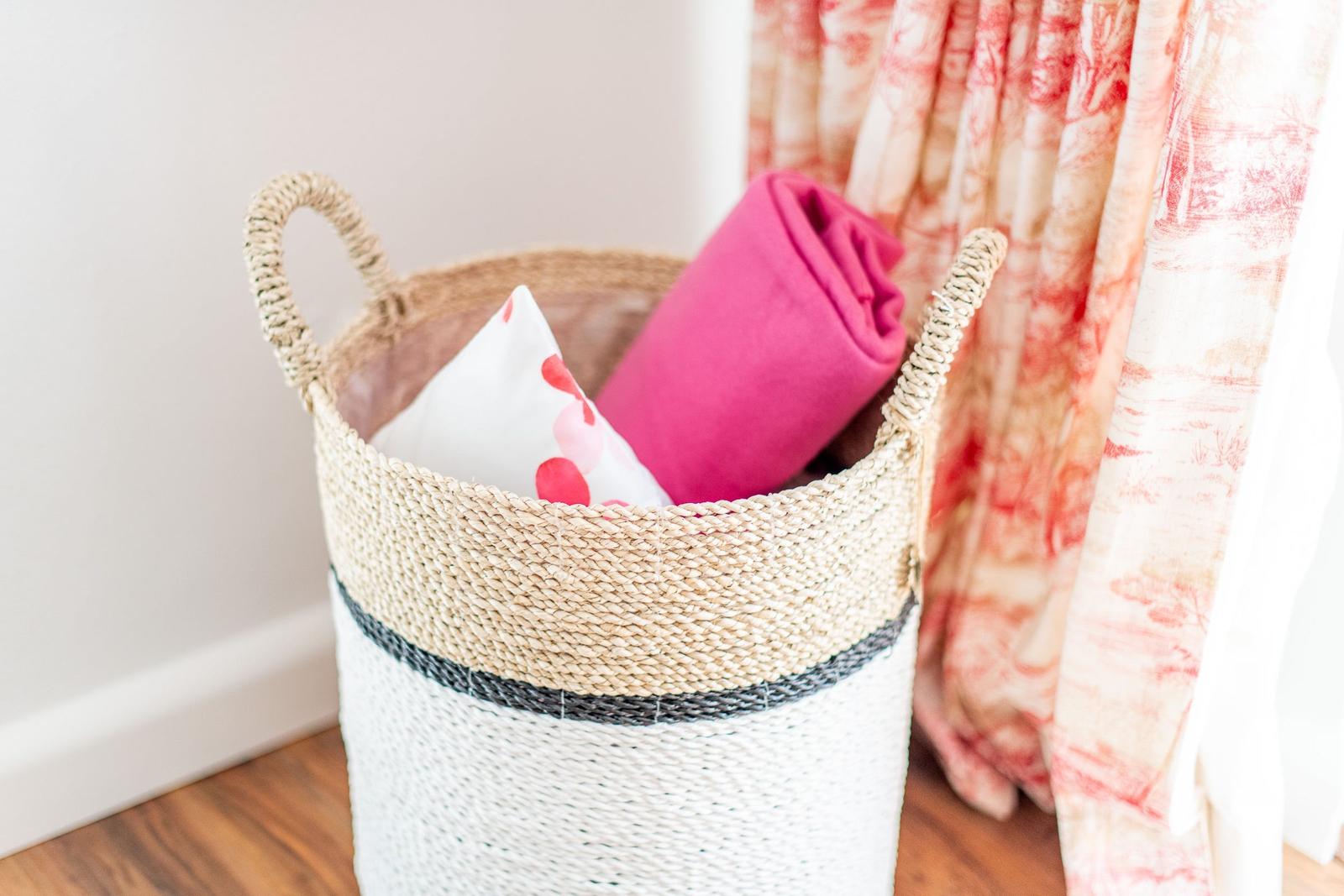 Living room with basket, pillows, and curtains