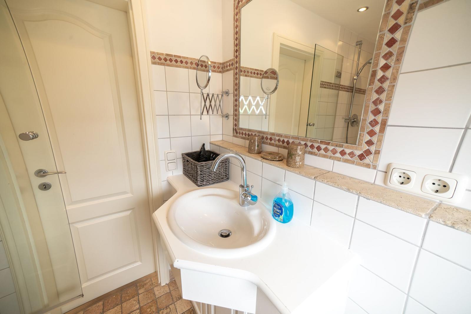 Bathroom with sink, mirror, and shower